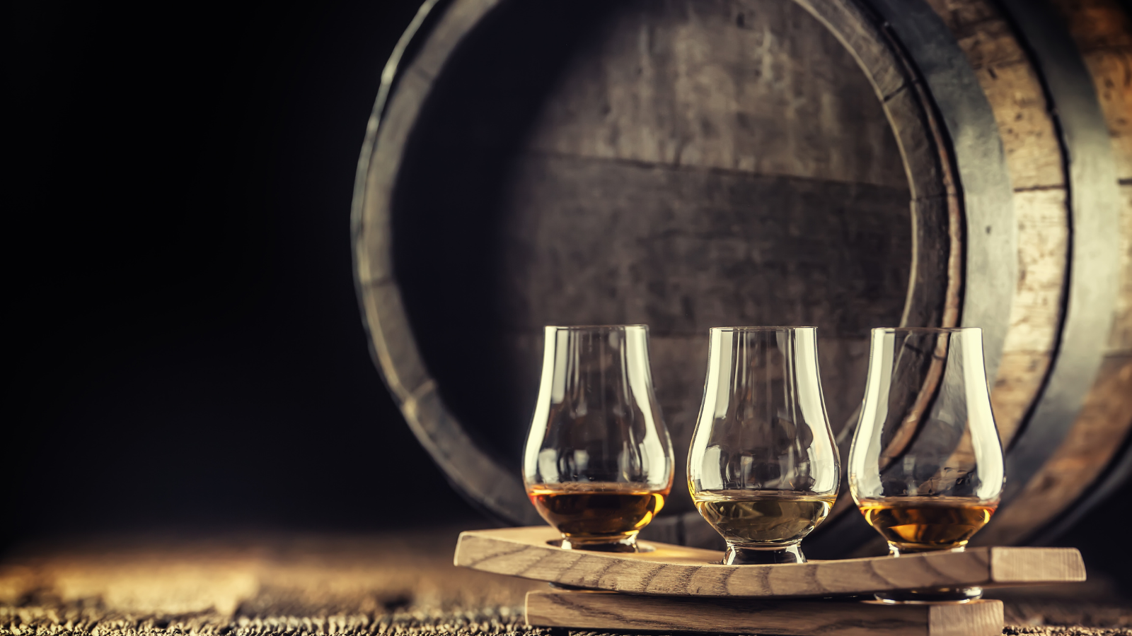 Glasses of whisky and a barrel